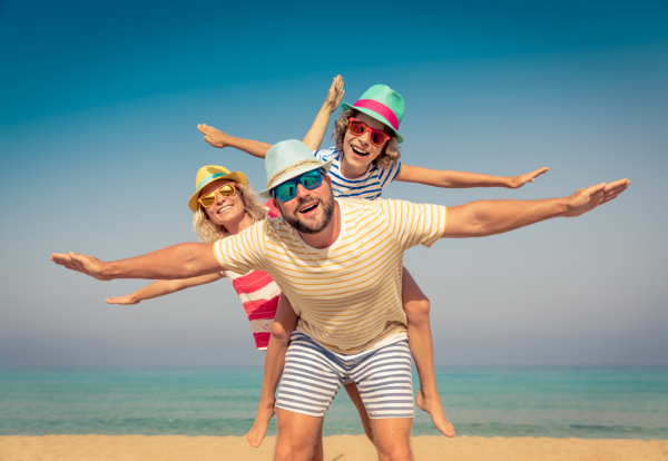 Family enjoying Son Bou beach in Menorca, a perfect destination for a vacation in the Balearic Islands.